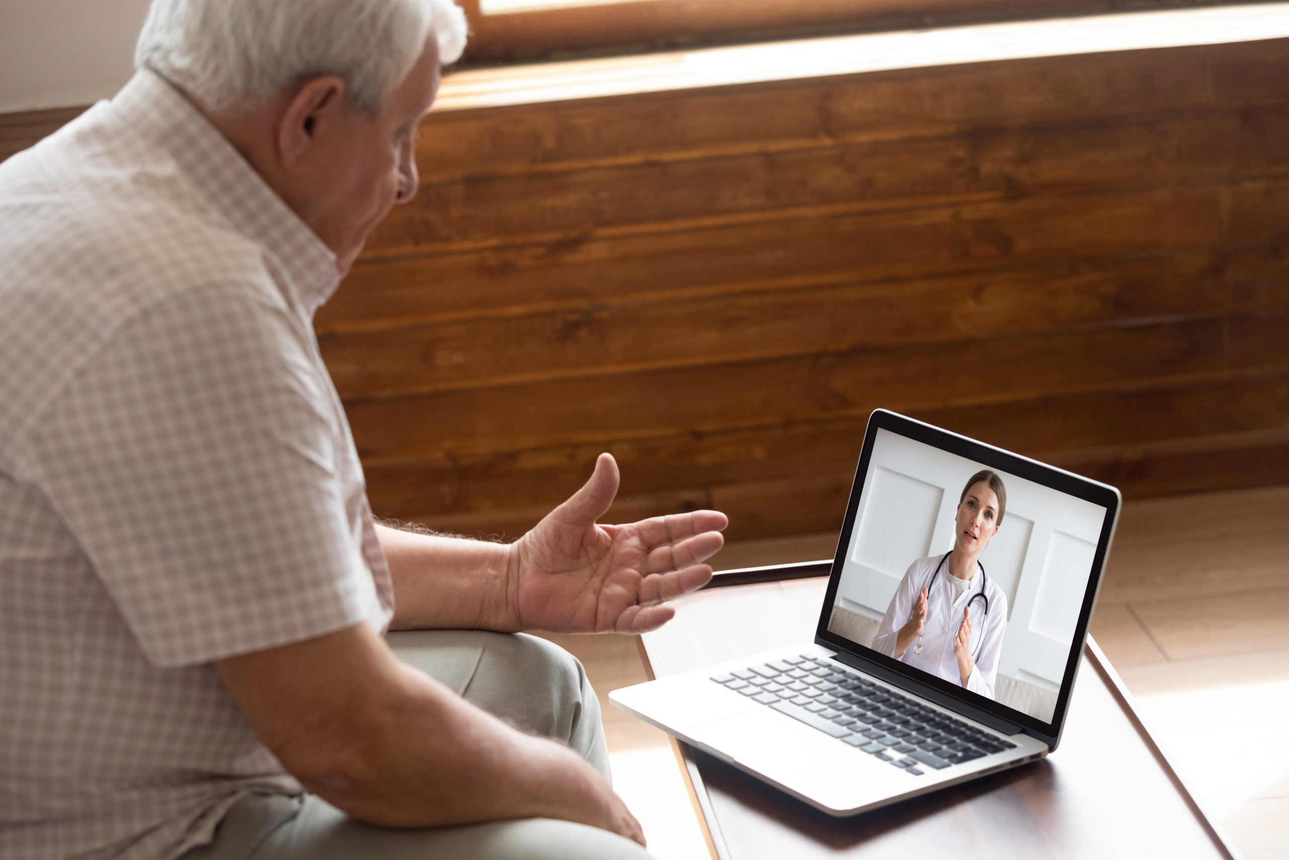 Elderly man has a telemedicine visit with his doctor